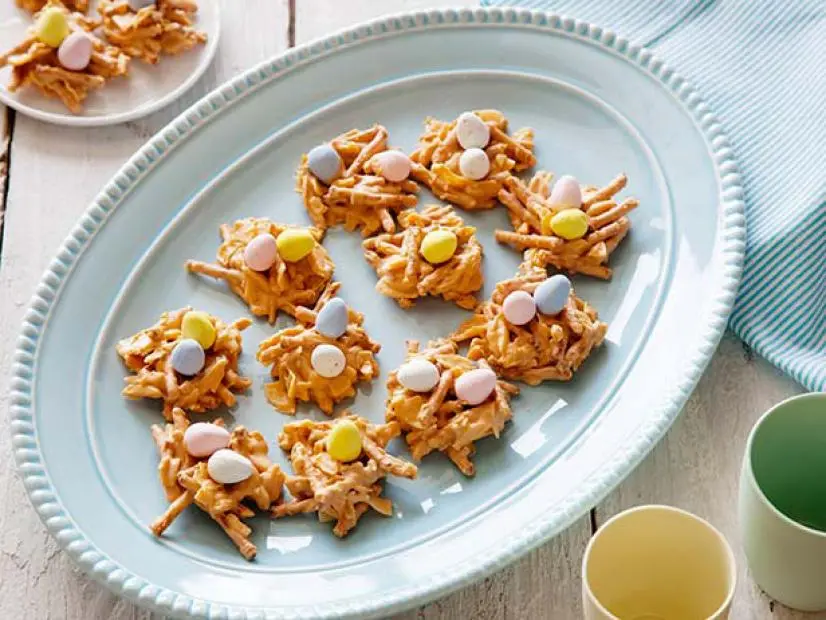 Golden butterscotch clusters shaped like bird nests filled with colorful candy-coated chocolate eggs